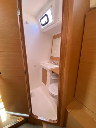  Yacht Photos Pics 2017 Dufour Exclusive 56 yacht bathroom with wooden accents and modern fixtures.
