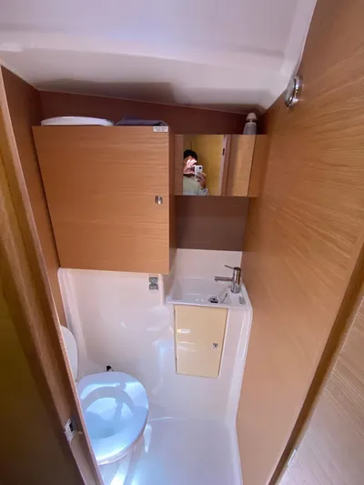  Yacht Photos Pics Bathroom interior of 2017 Dufour Exclusive 56 yacht with wooden cabinetry.