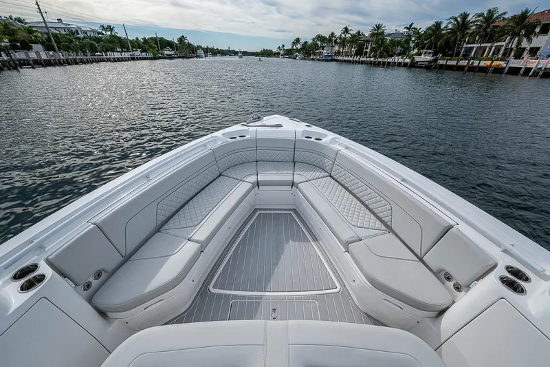  Yacht Photos Pics Luxurious seating on 2023 Intrepid 427 Nomad SE boat, cruising along a scenic waterway.