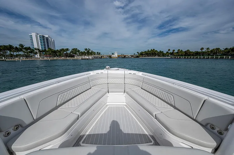  Yacht Photos Pics 2023 Intrepid 427 Nomad SE boat with spacious seating, cruising on calm waters.