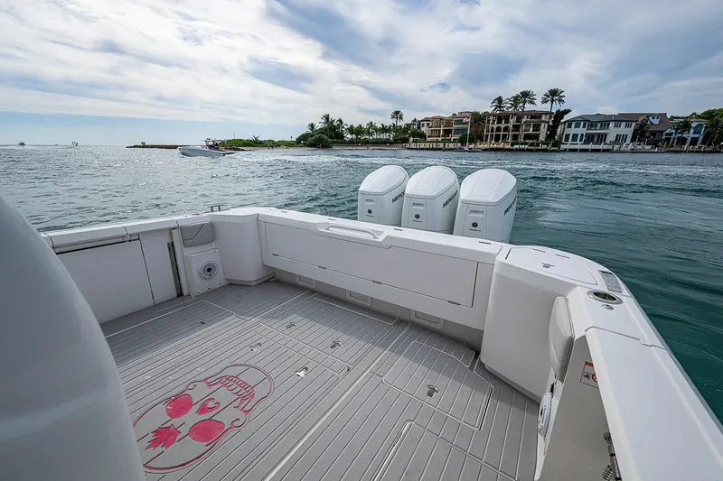  Yacht Photos Pics 2023 Intrepid 427 Nomad SE boat with triple engines, coastal view, luxury waterfront homes.