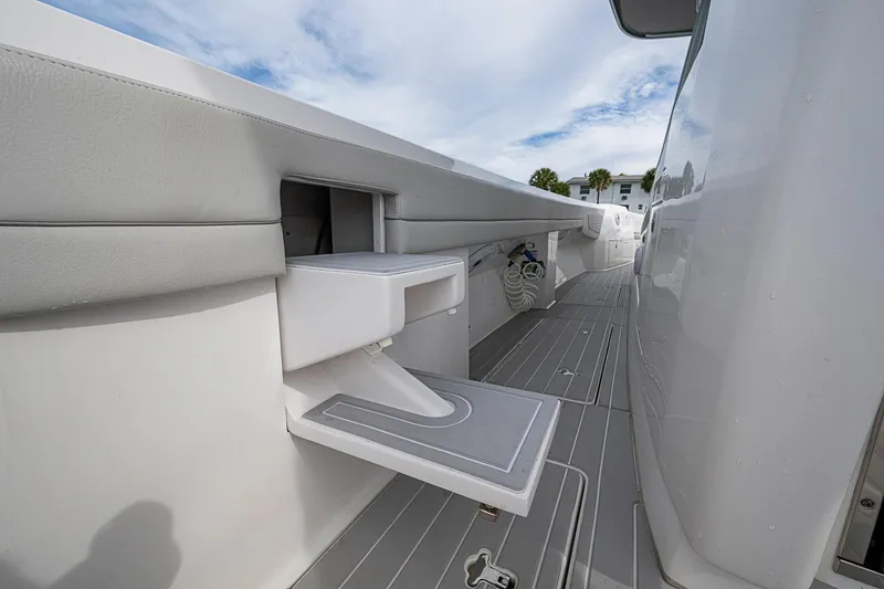  Yacht Photos Pics 2023 Intrepid 427 Nomad SE boat interior with fold-out step and sleek design.