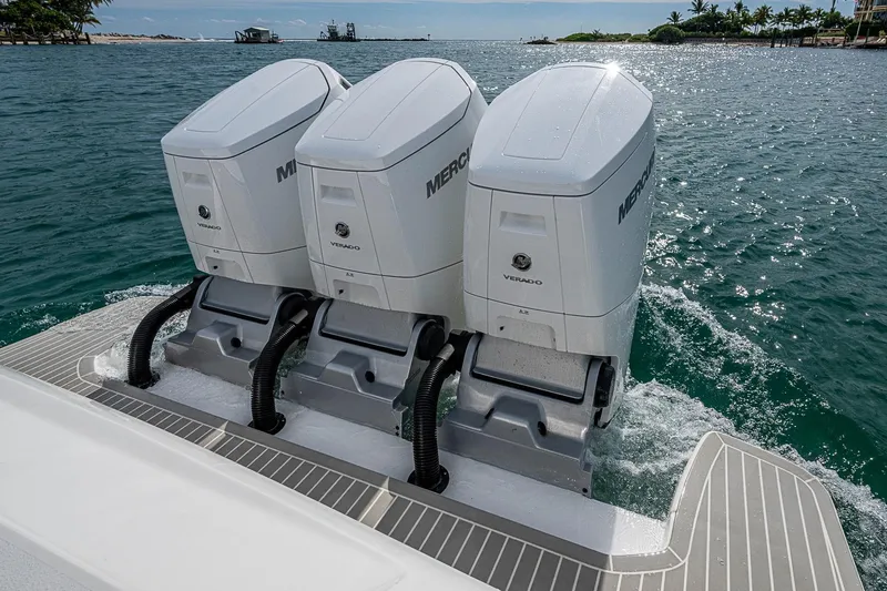  Yacht Photos Pics Triple Mercury Verado engines on 2023 Intrepid 427 Nomad SE, cruising in clear waters.