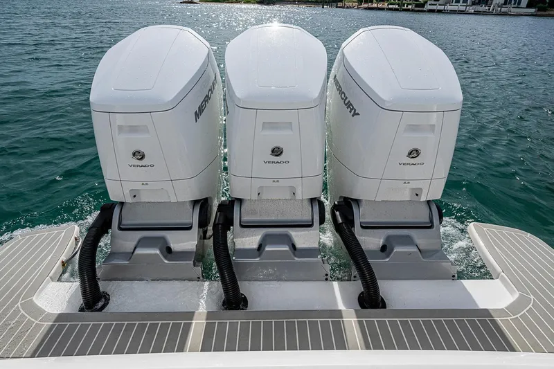  Yacht Photos Pics Triple Mercury Verado engines on 2023 Intrepid 427 Nomad SE boat, docked on water.