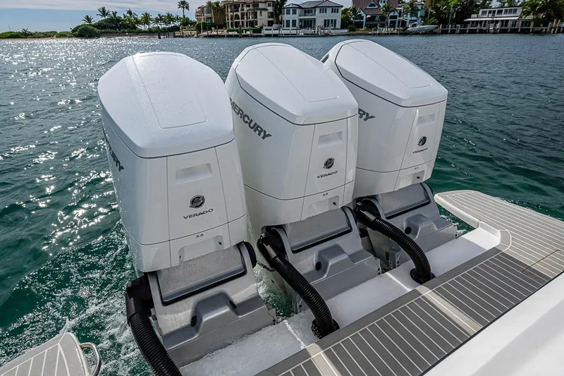  Yacht Photos Pics Triple Mercury Verado engines on 2023 Intrepid 427 Nomad SE, docked by waterfront homes.