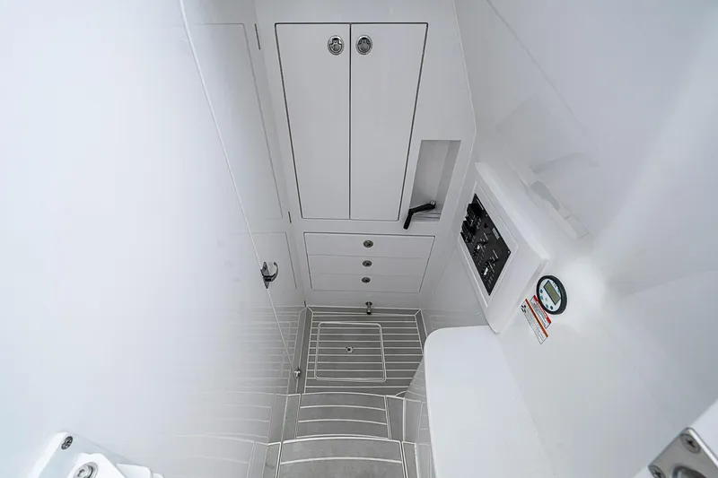  Yacht Photos Pics 2023 Intrepid 427 Nomad SE interior cabin with storage and control panel.