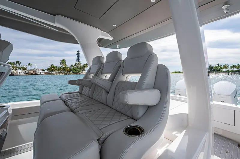  Yacht Photos Pics 2023 Intrepid 427 Nomad SE luxury seating with ocean view and palm trees.