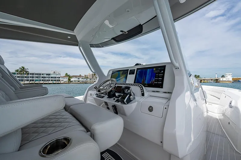  Yacht Photos Pics 2023 Intrepid 427 Nomad SE boat interior with modern dashboard and luxurious seating.