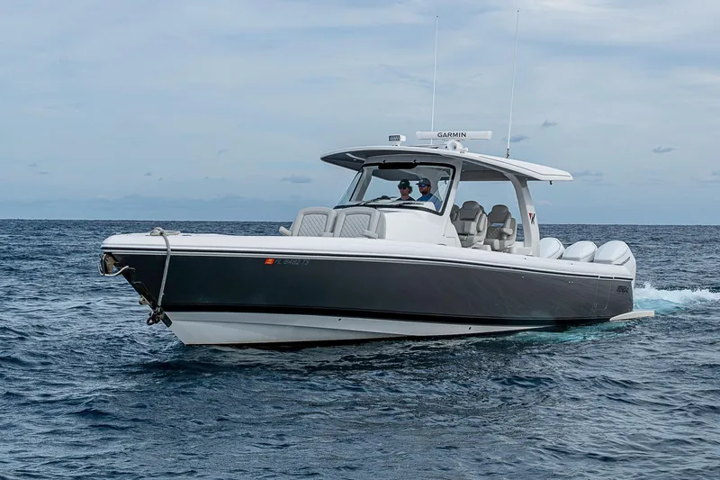  Yacht Photos Pics 2023 Intrepid 427 Nomad SE cruising on open water under a cloudy sky.