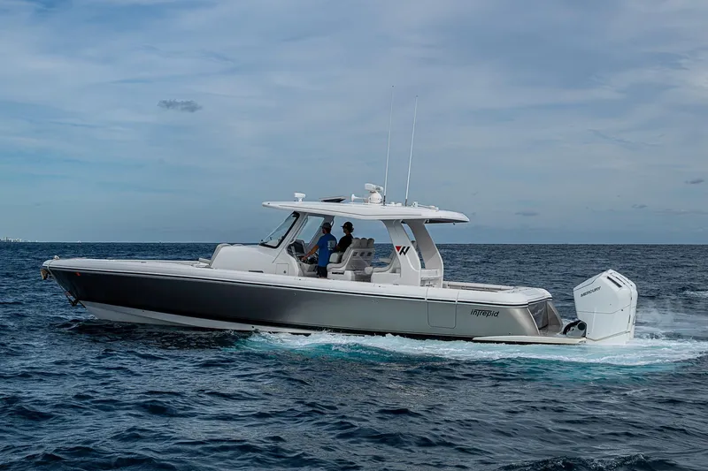  Yacht Photos Pics 2023 Intrepid 427 Nomad SE cruising on open water under a cloudy sky.