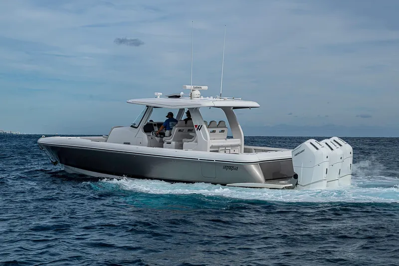  Yacht Photos Pics 2023 Intrepid 427 Nomad SE cruising on open water, showcasing sleek design and powerful engines.
