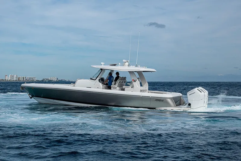  Yacht Photos Pics 2023 Intrepid 427 Nomad SE cruising on open water under a clear sky.