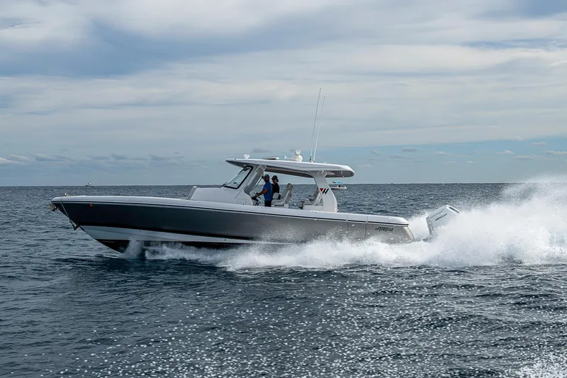  Yacht Photos Pics 2023 Intrepid 427 Nomad SE cruising on open water under a cloudy sky.