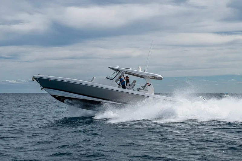 Yacht Photos Pics 2023 Intrepid 427 Nomad SE cruising on open water under cloudy skies.
