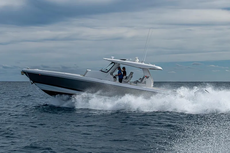  Yacht Photos Pics 2023 Intrepid 427 Nomad SE cruising on open water under cloudy skies.