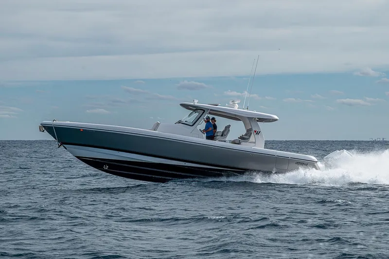  Yacht Photos Pics 2023 Intrepid 427 Nomad SE cruising on open water under a cloudy sky.
