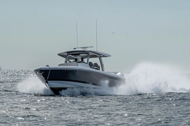  Yacht Photos Pics 2023 Intrepid 427 Nomad SE cruising on open water, creating a dynamic splash.