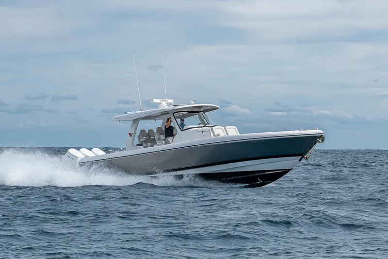  Yacht Photos Pics 2023 Intrepid 427 Nomad SE cruising on open water under a cloudy sky.