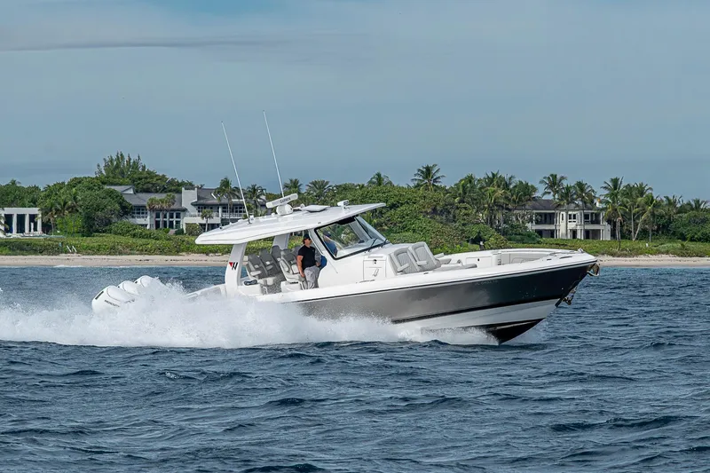  Yacht Photos Pics 2023 Intrepid 427 Nomad SE cruising on ocean near tropical coastline.
