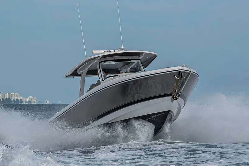  Yacht Photos Pics 2023 Intrepid 427 Nomad SE cruising on ocean waves, showcasing sleek design and performance.