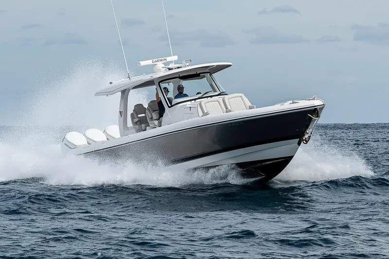 Yacht Photos Pics 2023 Intrepid 427 Nomad SE boat cruising on open water, showcasing sleek design and performance.
