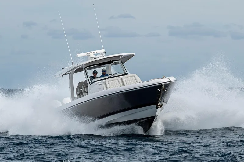  Yacht Photos Pics 2023 Intrepid 427 Nomad SE boat navigating through ocean waves.