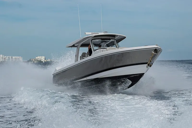  Yacht Photos Pics 2023 Intrepid 427 Nomad SE cruising on open water, creating a dynamic wake.