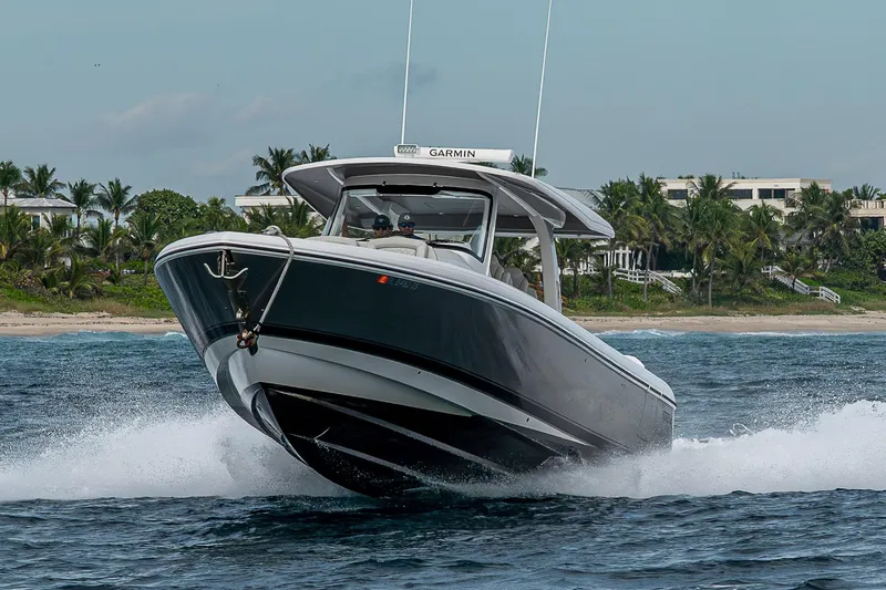  Yacht Photos Pics 2023 Intrepid 427 Nomad SE cruising on ocean near tropical shoreline.