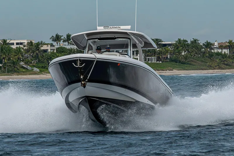  Yacht Photos Pics 2023 Intrepid 427 Nomad SE cruising on water near tropical shoreline.