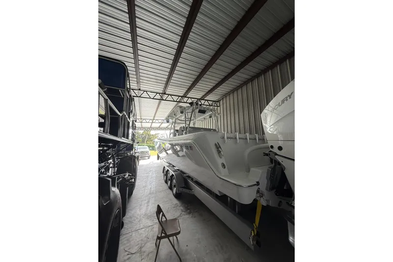  Yacht Photos Pics 2025 Contender 44 ST boat in storage, featuring sleek design and powerful Mercury engines.