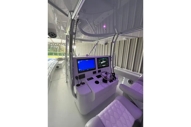  Yacht Photos Pics 2025 Contender 44 ST boat cockpit with advanced navigation system and modern seating.