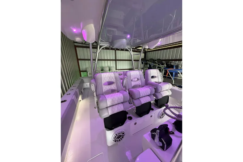  Yacht Photos Pics 2025 Contender 44 ST boat interior with luxurious seating and ambient lighting.