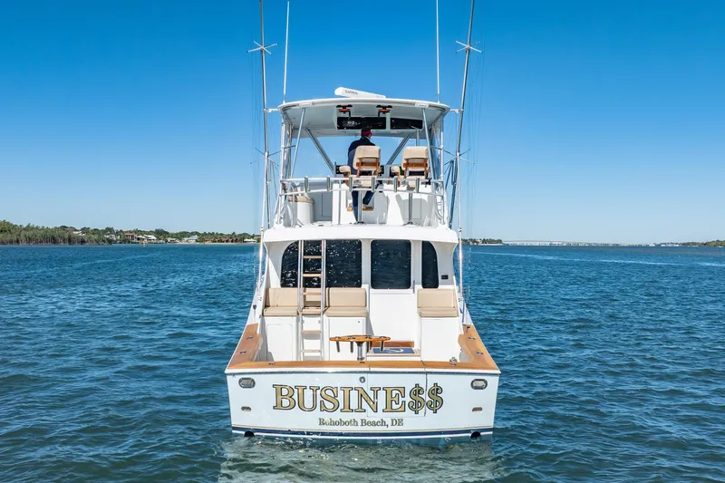 Business Yacht Photos Pics Luxury yacht "BUSINE$$" on water, Rehoboth Beach, DE, clear blue sky.