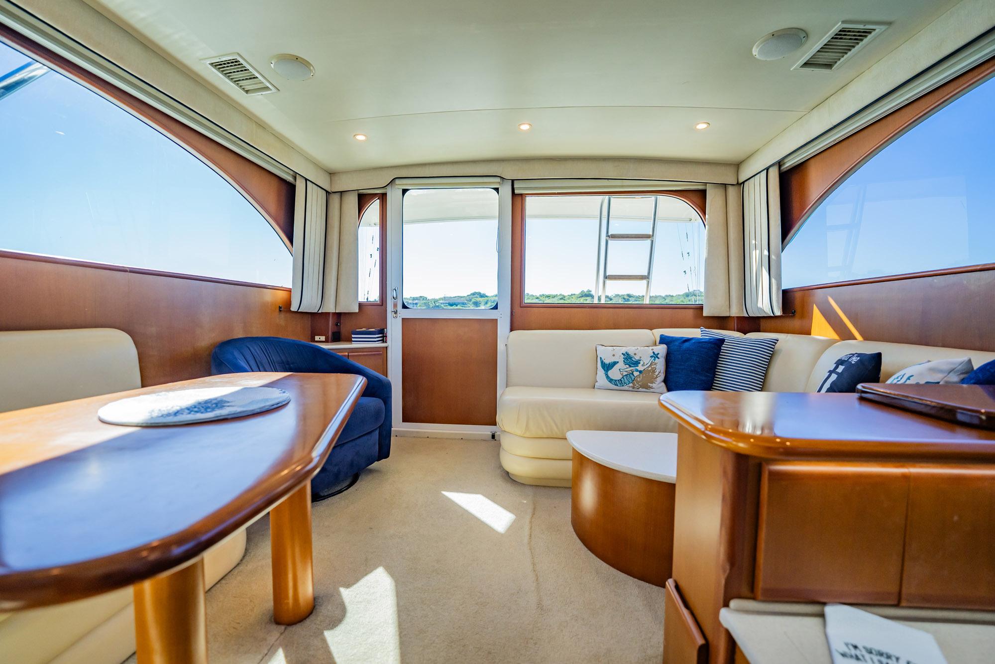 Luxurious interior of 2001 Post 42 yacht with elegant seating and natural light.