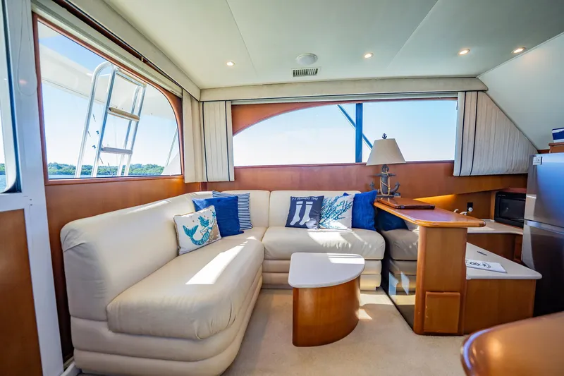 Business Yacht Photos Pics Luxurious interior of a 2001 Post 42 yacht with cozy seating and nautical decor.