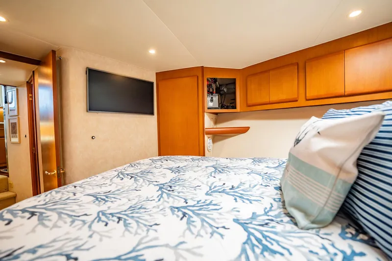 Business Yacht Photos Pics Luxurious cabin interior of 2001 Post 42 yacht with cozy bedding and modern amenities.