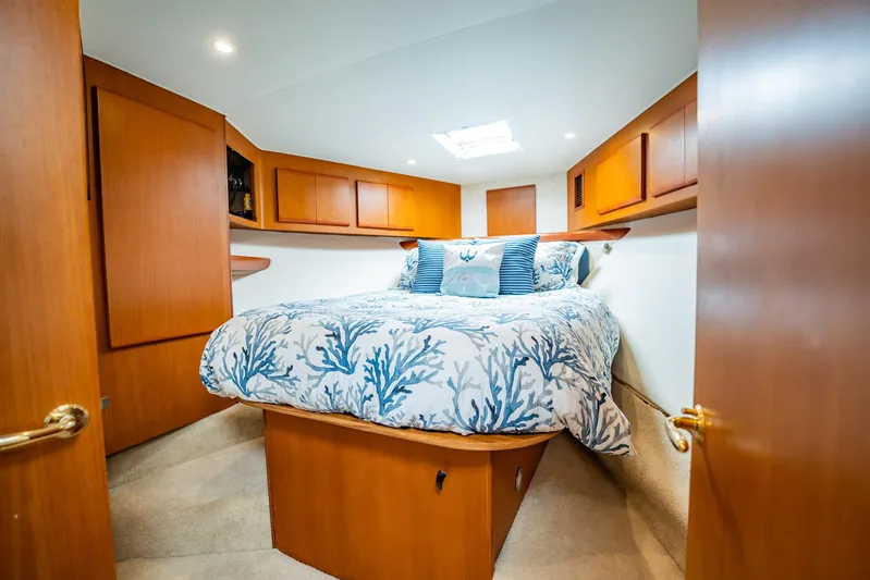 Business Yacht Photos Pics Luxurious cabin interior of 2001 Post 42 yacht with cozy bedding and wooden cabinetry.