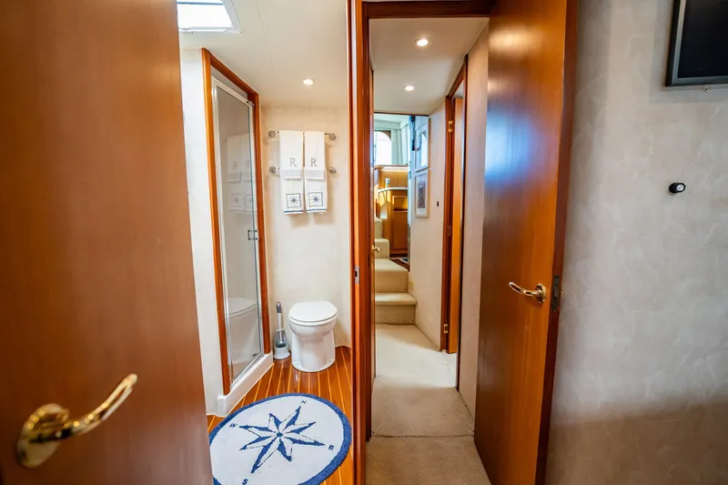 Business Yacht Photos Pics Luxurious yacht bathroom with wooden doors, compass rug, and modern fixtures, Post 42 model, 2001.