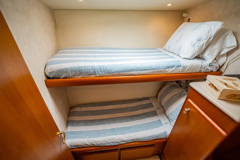 Business Yacht Photos Pics Bunk beds in a 2001 Post 42 model yacht cabin with striped bedding.