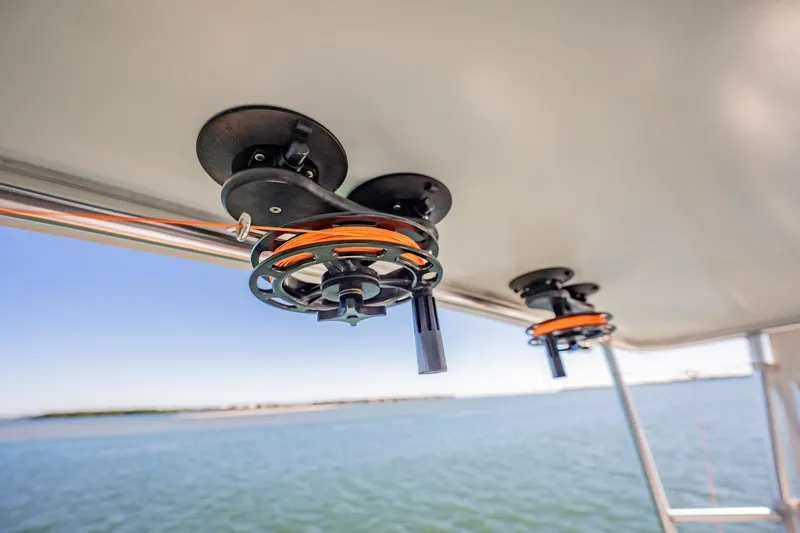 Business Yacht Photos Pics Boat roof with mounted fishing rod holders, Post 42 model, 2001, overlooking calm waters.