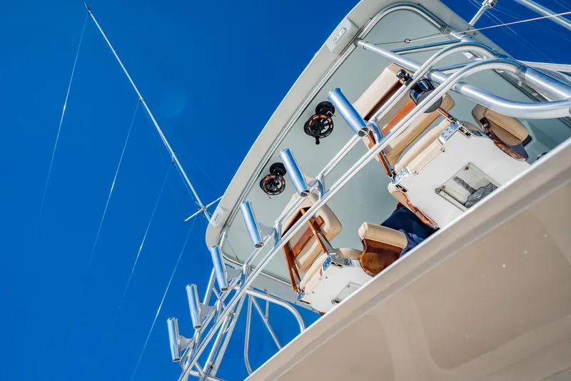 Business Yacht Photos Pics Luxury yacht deck with fishing rods against clear blue sky, Post 42 model, 2001.