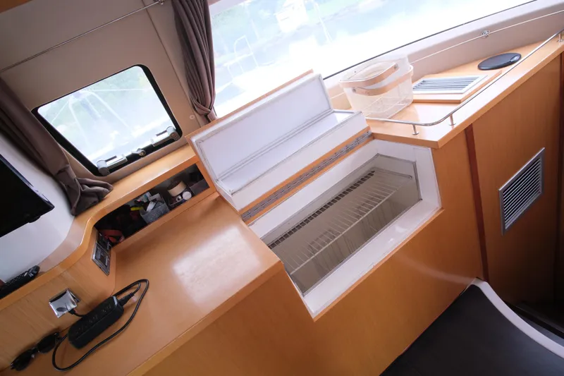 Northern Lynx Yacht Photos Pics Interior of 2011 Fountaine Pajot Salina 48 Evolution Maestro yacht with open storage compartment.