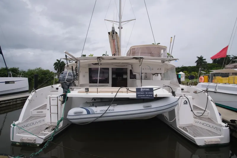 Northern Lynx Yacht Photos Pics 2011 Fountaine Pajot Salina 48 Evolution Maestro catamaran docked with dinghy attached.
