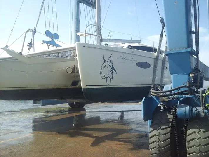 Northern Lynx Yacht Photos Pics 2011 Fountaine Pajot Salina 48 Evolution catamaran being lifted by a boat hoist.