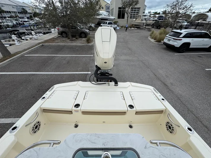  Yacht Photos Pics 2025 Scout 261 XSS boat in parking lot, rear view with motor and seating area.