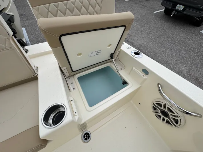  Yacht Photos Pics 2025 Scout 261 XSS boat interior with open storage compartment and speaker.