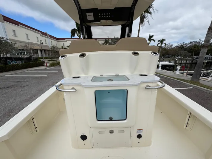  Yacht Photos Pics 2025 Scout 261 XSS boat interior with seating and storage, parked outdoors.