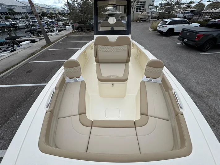  Yacht Photos Pics 2025 Scout 261 XSS boat with beige seating, docked in a marina parking area.