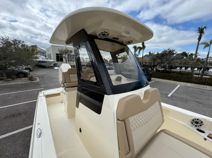  Yacht Photos Pics 2025 Scout 261 XSS boat with sleek design, parked outdoors under cloudy sky.