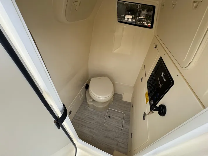  Yacht Photos Pics 2025 Scout 261 XSS boat interior bathroom with toilet and control panel.